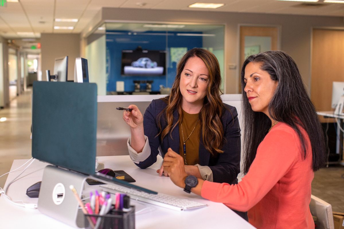 Colleagues entering records into a system