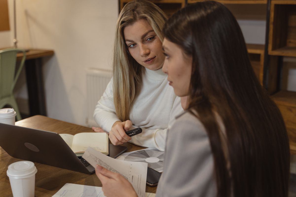 Team reviewing listings on a laptop